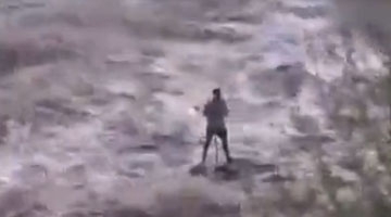 惊险!男子钓鱼突遇山洪暴发 被滚滚洪水困河中心