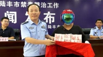 男子举报毒贩获奖励 戴头盔领走百万元现金