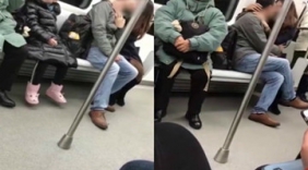 情侣地铁上忘情热吻 老人孩子互换座位遮挡